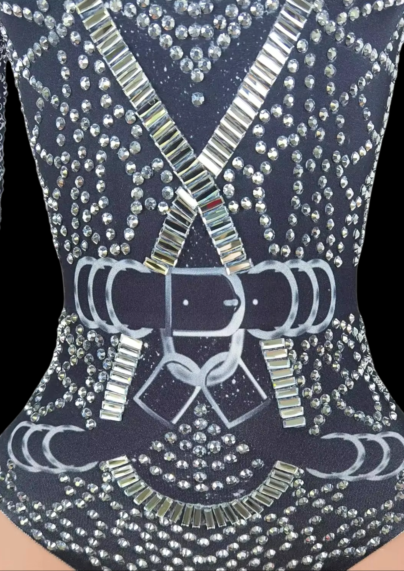 Party romper with intricate silver embellishments on a dark fabric.