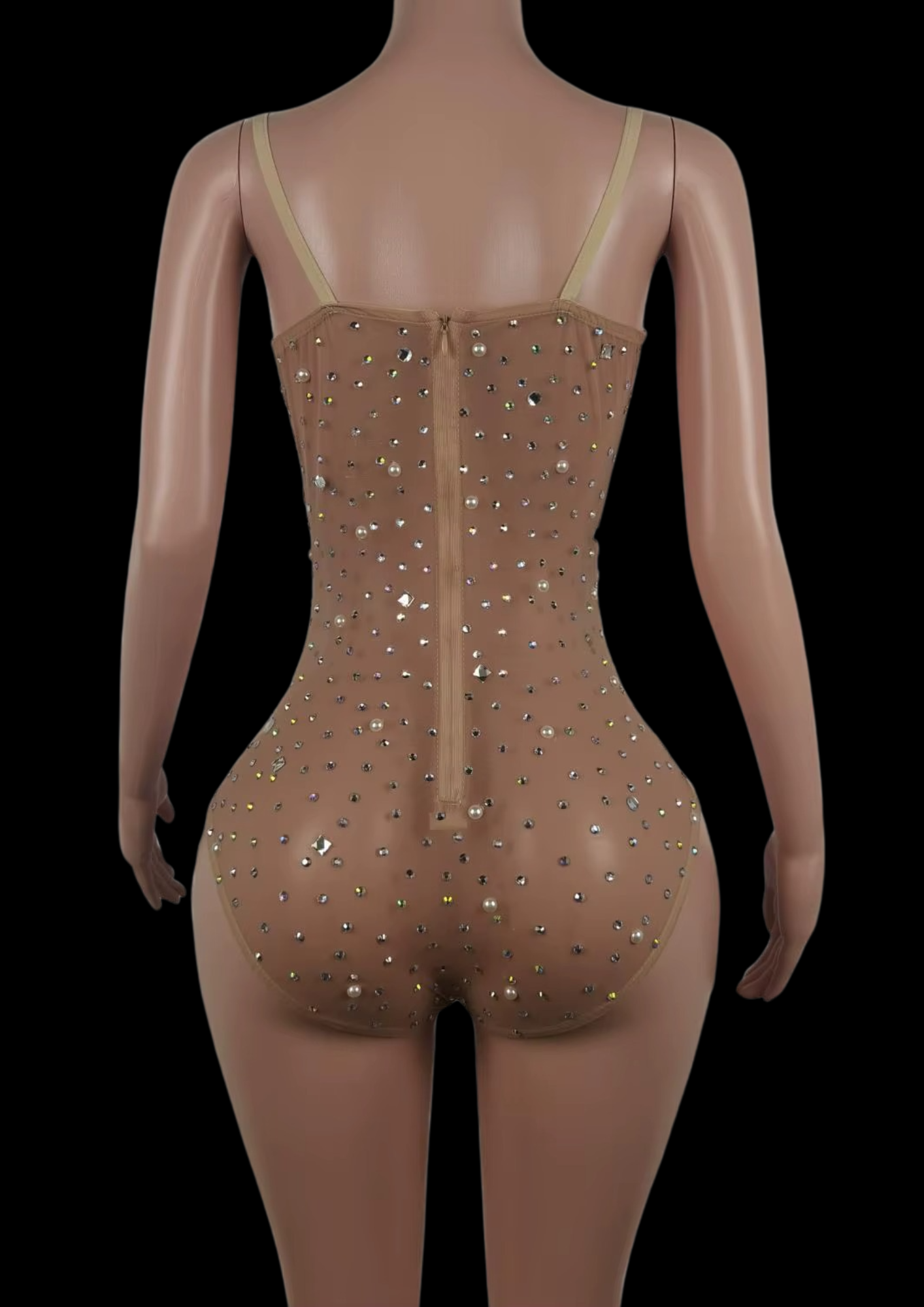 Back view of a nude-toned party romper with sparkling embellishments on a mannequin.