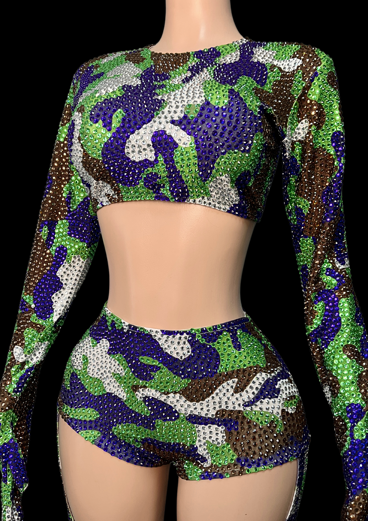 Party costume set inspired by Beyoncé in camo print with rhinestones, featuring long sleeves and shorts.