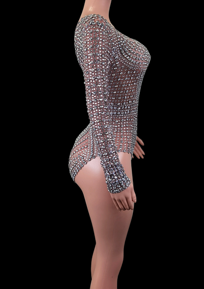 Party romper with shimmering details on mannequin, side view.