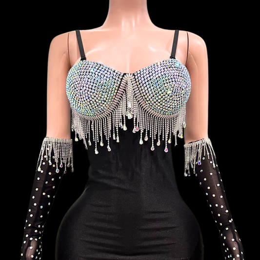 Mini dress with sparkling crystal embellishments and matching gloves on a mannequin.