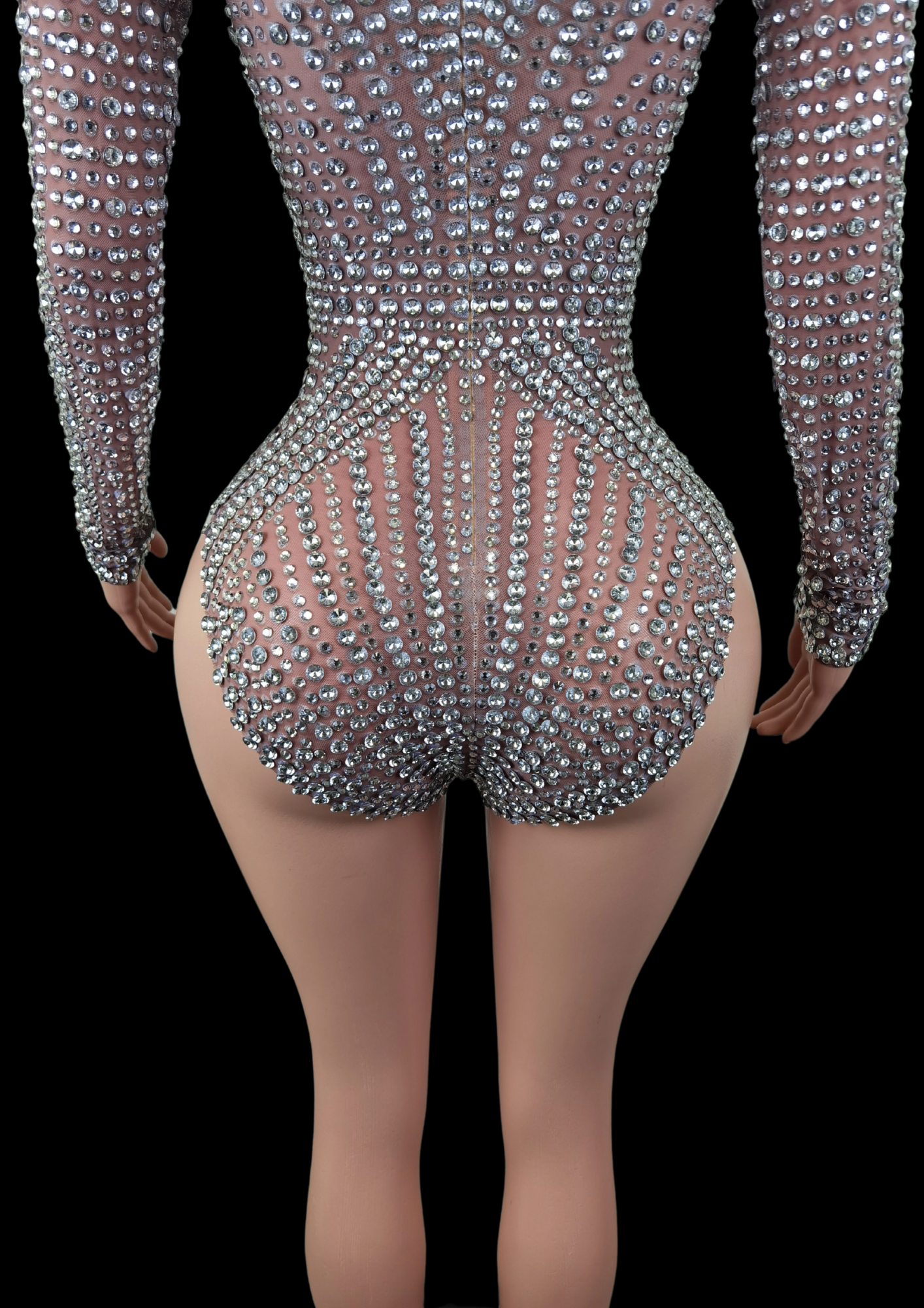 Sparkling party romper with intricate embellishments.