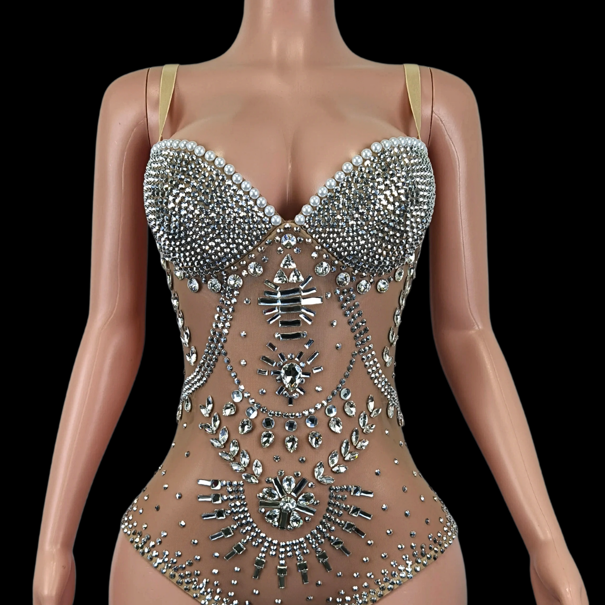 Elegant embellished party romper on mannequin display.