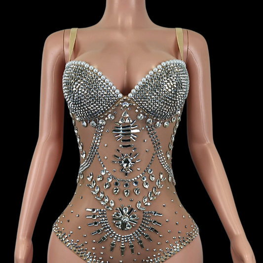 Elegant embellished party romper on mannequin display.