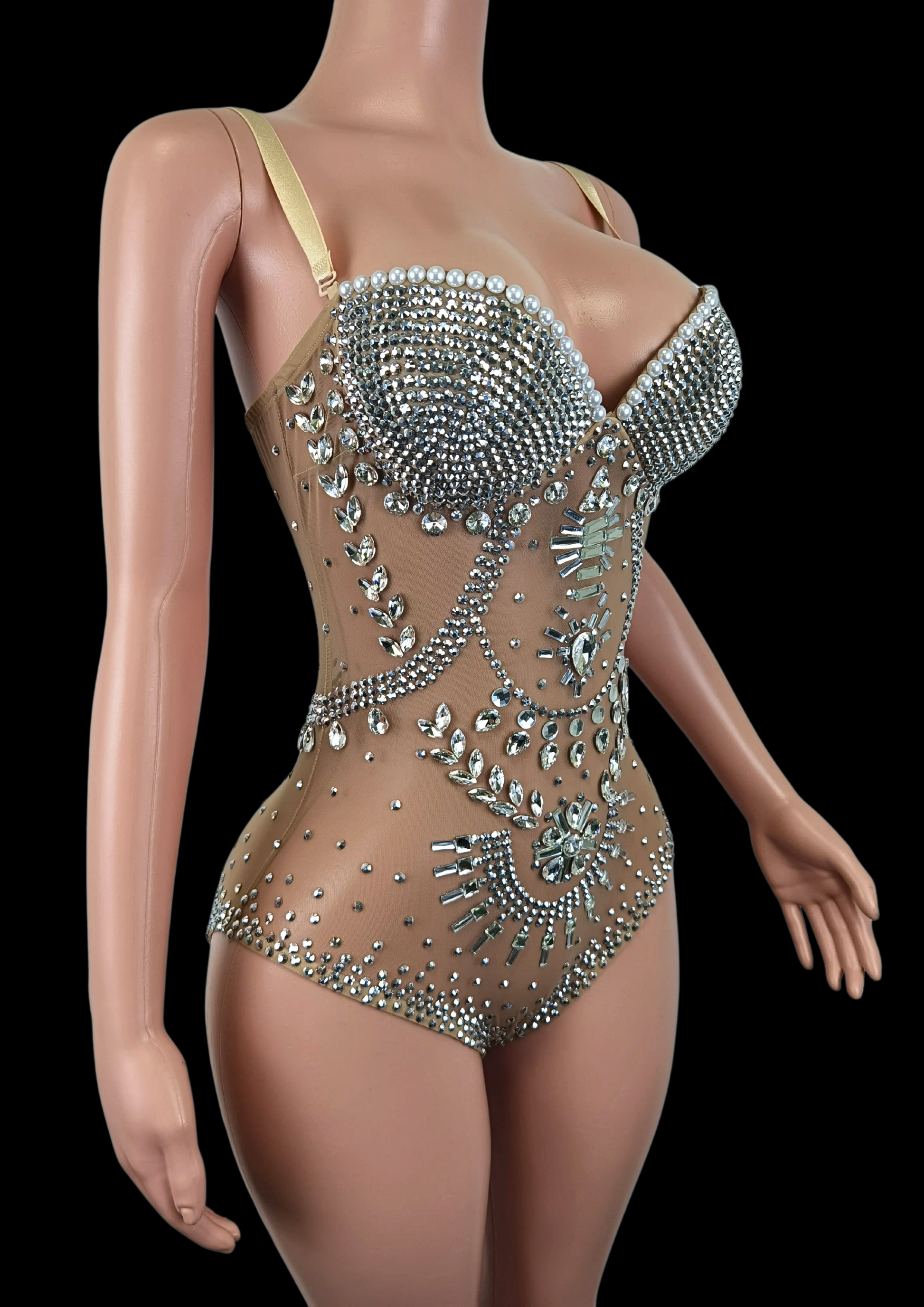 Elegant party romper with intricate rhinestone embellishments on a mannequin.
