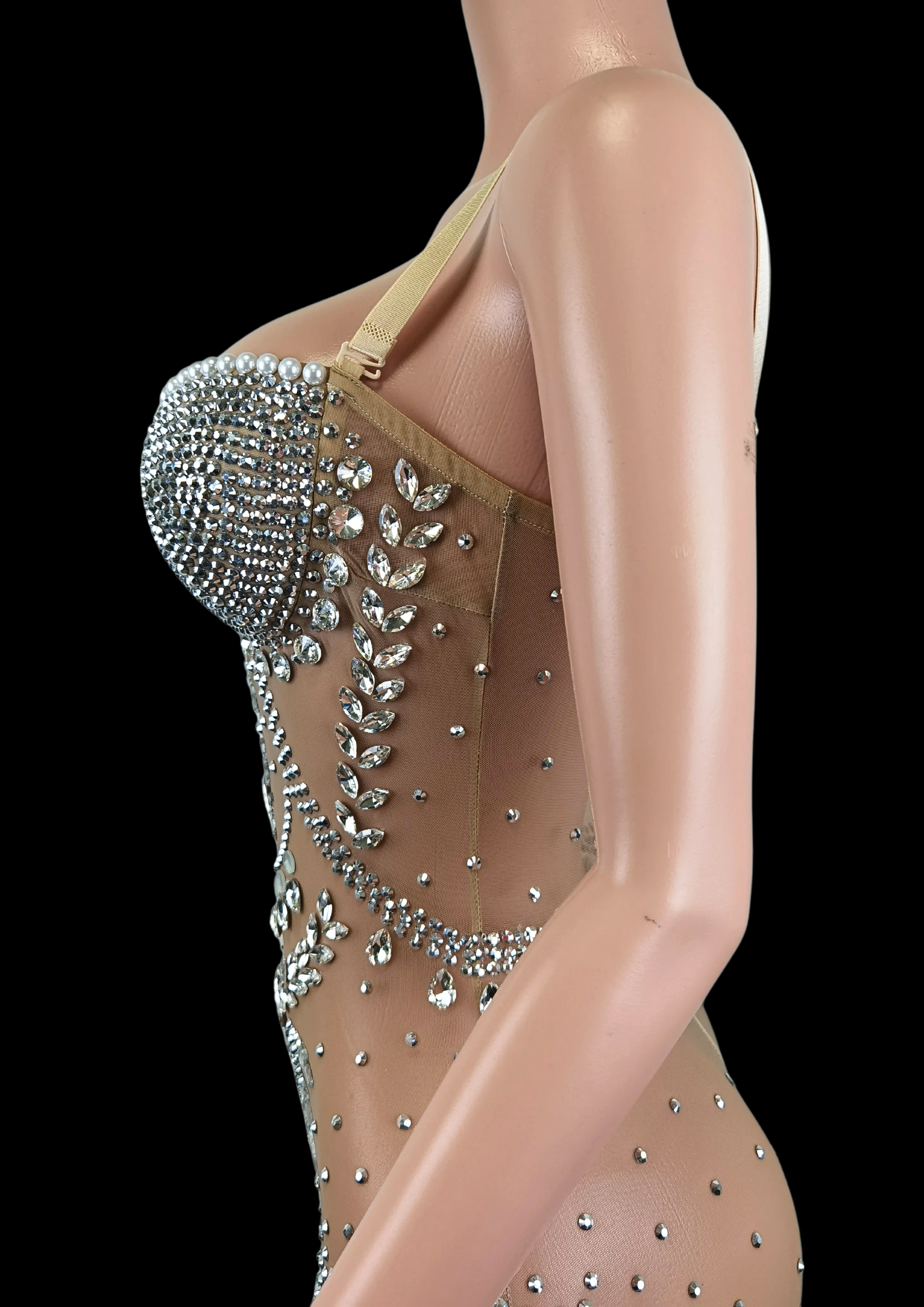 Party romper with intricate beadwork on mannequin.